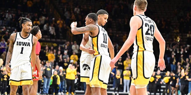 Iowa players celebrate on the court after winning a college basketball game between the Maryland Terrapins and the Iowa Hawkeyes on January 15, 2023 at Carver-Hawkeye Arena in Iowa City, IA 