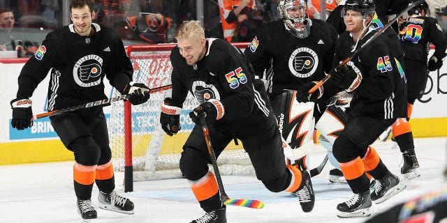 Joel Farabee #86, Rasmus Ristolainen #55, Carter Hart #79, and Cam York #45 of the Philadelphia Flyers skate during warmups prior to their game against the Anaheim Ducks at the Wells Fargo Center on January 17, 2023 in Philadelphia, Pennsylvania. The Flyers are wearing limited edition jerseys during warmups to celebrate Pride Night tonight.