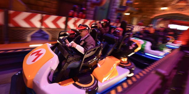 Guests ride Super Mario Kart during a preview of Super Nintendo World at Universal Studios in Los Angeles, California, on January 13, 2023.