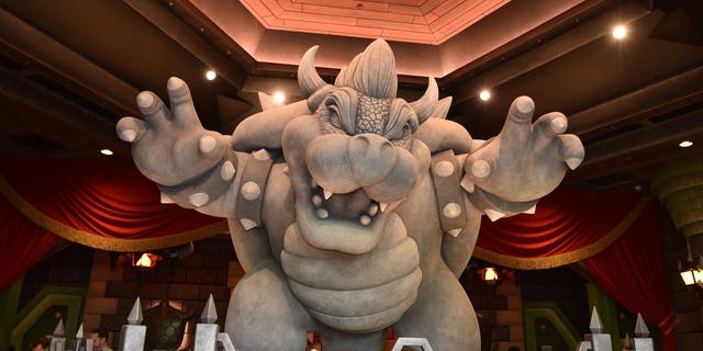 A statue of Bowser is seen at the entrance of the Mario Kart Bowser's Challenge ride during a preview of Super Nintendo World at Universal Studios in Los Angeles, California, on January 13, 2023.