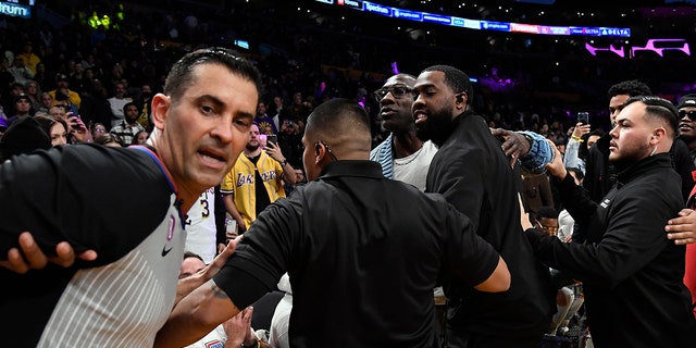 Shannon Sharpe and Tee Morant, father of Ja Morant, #12 of the Memphis Grizzlies, are separated by security and referees after a verbal altercation between Sharp and Morant during halftime against the Los Angeles Lakers at Crypto.com Arena on January 20 .  2023 in Los Angeles.