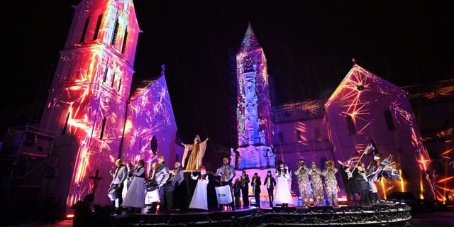 Musicians and dancers perform on stage in front of the light-painted churches in Veszprem, Hungary, during the grand opening on Jan. 21, 2023, as the town and its region became the 2023 European Capital of Culture along with Elefsina, Greece, and Timisoara, Romania.