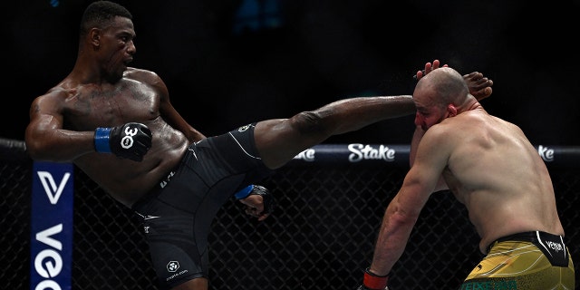 Brazilian Glover Teixera (R) competes against US Jamahal Hill during their light heavyweight title bout at the Ultimate Fighting Championship (UFC) event at the Jeunesse Arena in Rio de Janeiro, Brazil, on Jan. 21, 2023.