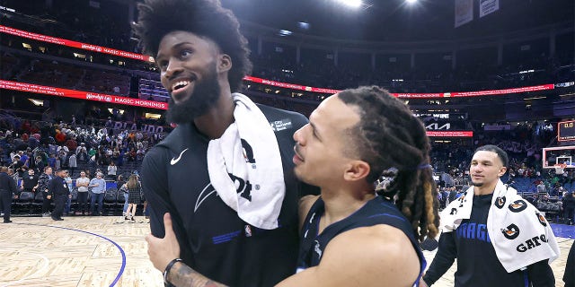 Orlando guard Cole Anthony, right, hugs forward Jonathan Isaac, left, after winning the Boston Celtics at Orlando Magic NBA game at the Amway Center in Orlando on Monday, Jan. 23, 2023. Orlando won the game 113-98.
