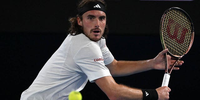 Greece's Stefanos Tsitsipas hits a return against the Czech Republic's Jiri Lehecka during their men's singles quarter-final match on day nine of the Australian Open tennis tournament in Melbourne on Jan. 24, 2023.