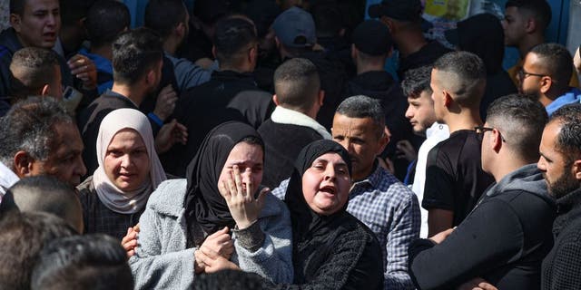 Family members of one of the 9 Palestinians reportedly killed during an Israeli raid on the West Bank's Jenin refugee camp, mourn his death during his funeral procession in the city of the same name on January 26, 2023. (JAAFAR ASHTIYEH/AFP via Getty Images)