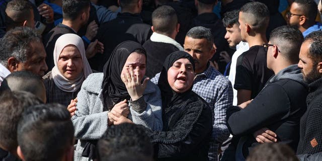 Family members of one of the 9 Palestinians reportedly killed during an Israeli raid on the West Bank's Jenin refugee camp, mourn his death during his funeral procession in the city of the same name on January 26, 2023. (JAAFAR ASHTIYEH/AFP via Getty Images)