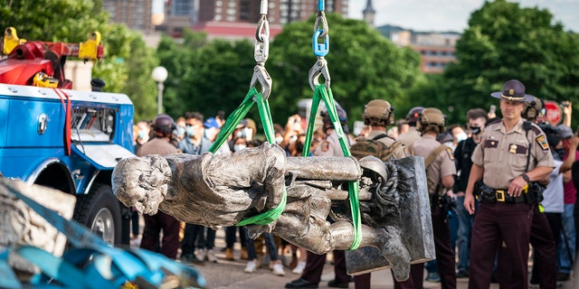 A tow truck removed the Christopher Columbus statue after it was toppled in front of the Minnesota State Capitol in St. Paul on Wednesday, June 10, 2020. 