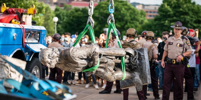 A tow truck removed the Christopher Columbus statue after it was toppled in front of the Minnesota State Capitol in St. Paul on Wednesday, June 10, 2020.