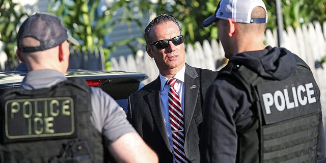 Todd Lyons, Immigration and Customs Enforcement Acting Field Office Director talks with his agents after they made three arrests on Sept. 25, 2019 in Revere, Massachusetts.  