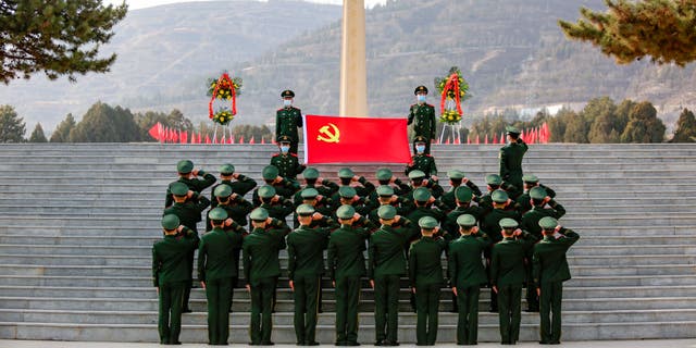 Soldiers of the local People's Armed Police Force pay respects to one of the four soldiers who died during a border clash with India in June 2020 at a martyrs' cemetery in Lanzhou, Gansu Province of China, on Feb. 24, 2021.