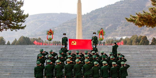 Soldiers of the local People's Armed Police Force pay respects to one of the four soldiers who died during a border clash with India in June 2020 at a martyrs' cemetery Feb. 24, 2021, in Lanzhou, Gansu Province of China.