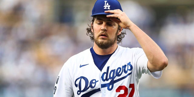 Trevor Bauer, #27 of the Los Angeles Dodgers, returns to the dugout after the top of the first inning against the San Francisco Giants at Dodger Stadium on June 28, 2021 in Los Angeles.