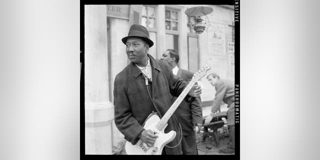 Blues musician Muddy Waters photographed at Wilbraham Road Station in Manchester, England, while filming the Granada Television special "Blues And Gospel Train," on May 7, 1964. "The blues had a baby and the named it rock ‘n’ roll," Waters sang in 1977, explaining the connection between the two American-made musical genres.