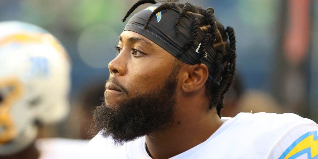 Los Angeles Chargers number 58 Jessie Lemonier watches the first quarter during the NFL preseason game against the Seattle Seahawks at Lumen Field on August 28, 2021 in Seattle.