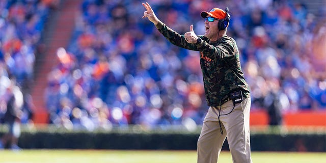 Florida Gators assistant head coach Tim Brewster signals during the first quarter of a game against the Samford Bulldogs at Ben Hill Griffin Stadium in Gainesville, Florida, on Nov. 13, 2021.