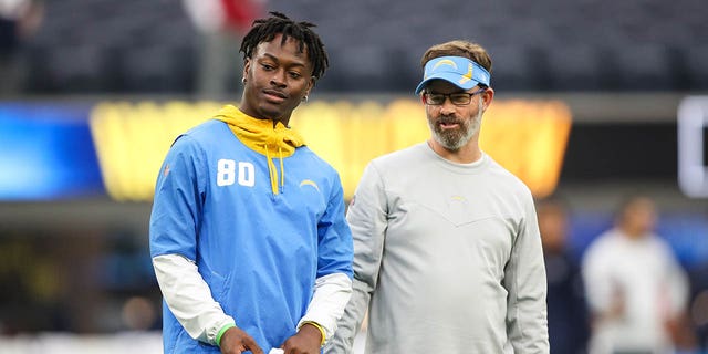 Maurice French of the Los Angeles Chargers, left, with offensive coach Shane Day during warmups ahead of a game against the New England Patriots at SoFi Stadium Oct. 31, 2021, in Inglewood, Calif. 