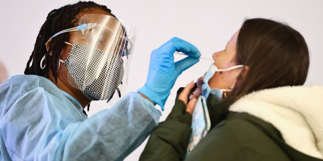 Merline Jimenez, left, administers a COVID-19 nasopharyngeal swab to a person at a testing site in the international terminal at Los Angeles International Airport (LAX) in December. The XBB subvariant will likely spread across the nation, Dr. Shad Marvasti said.