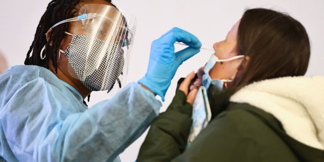 Merline Jimenez, left, administers a COVID-19 nasopharyngeal swab to a person at a testing site in the international terminal at Los Angeles International Airport (LAX) in December. The XBB subvariant will likely spread across the nation, Dr. Shad Marvasti said.