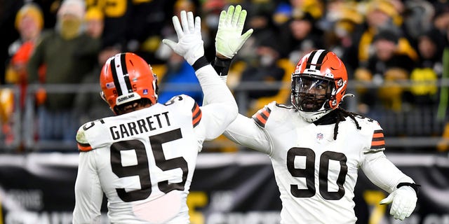 Myles Garrett, #95 of the Cleveland Browns, high fives with teammate Jadeveon Clowney, #90, in the third quarter against the Pittsburgh Steelers at Heinz Field on January 3, 2022, in Pittsburgh, Pennsylvania. 