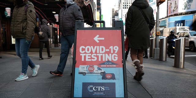 People pass a COVID-19 testing site on a Manhattan street on Jan. 21, 2022, in New York City.