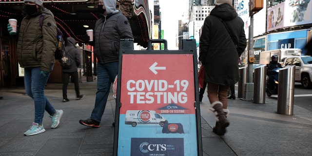 People are shown passing a COVID-19 testing site along a Manhattan street on Jan. 21, 2022 in New York City. Omincron variants are known for attacking the upper respiratory tract – the nose and sinuses – instead of the lungs, said Dr. Marvasti.