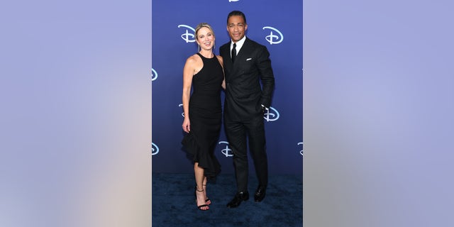 T.J. Holmes and Amy Robach grin  connected  the reddish  carpet unneurotic  astatine  the ABC Disney Upfront successful  May.