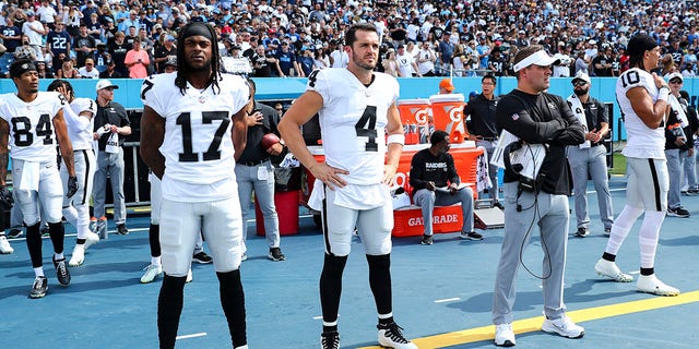 Davante Adams, #17, Derek Carr, #4, and head coach Josh McDaniels of the Las Vegas Raiders stand on the sidelines prior to an NFL football game against the Tennessee Titans at Nissan Stadium on September 25, 2022, in Nashville, Tennessee. 