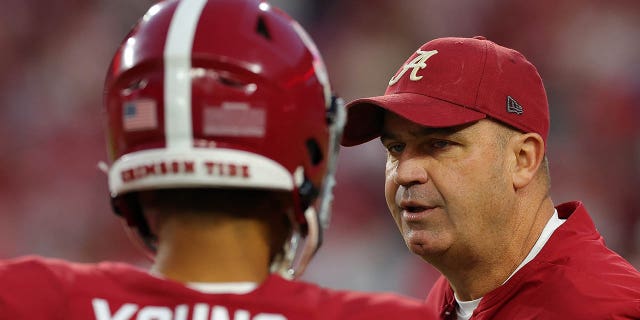 Offensive coordinator Bill O'Brien converses with Bryce Young of the Crimson Tide during pregame warmups at Bryant-Denny Stadium on Oct. 8, 2022, in Tuscaloosa, Alabama.