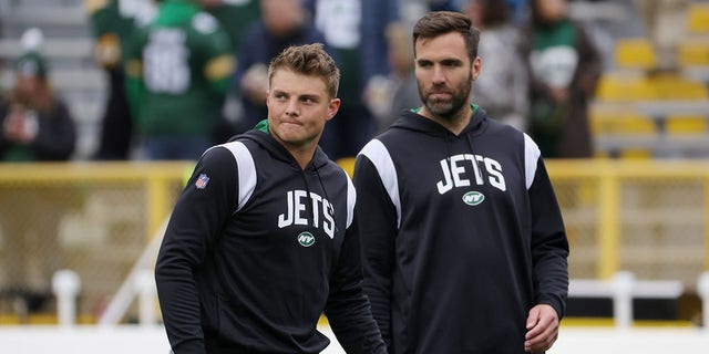 Zach Wilson, left, and Joe Flacco of the New York Jets during pregame at Lambeau Field Oct. 16, 2022, in Green Bay, Wis. 