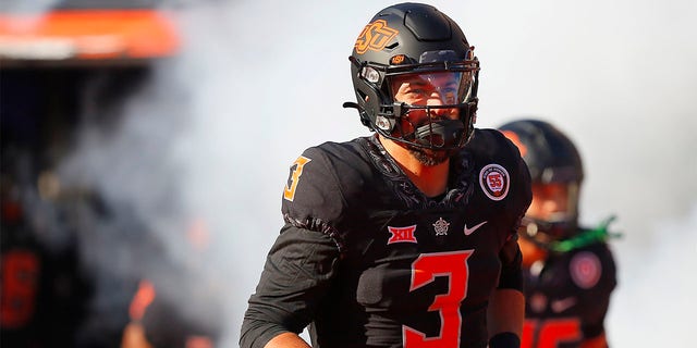 Oklahoma State Cowboys quarterback Spencer Sanders runs onto the field for a game against the Iowa State Cyclones at Boone Pickens Stadium on November 12, 2022 in Stillwater, Oklahoma.