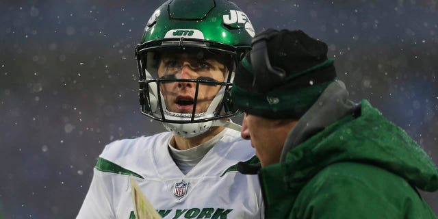 Mike White of the New York Jets talks with offensive coordinator Mike LaFleur during the Buffalo Bills game at Highmark Stadium on Dec. 11, 2022, in Orchard Park, New York.