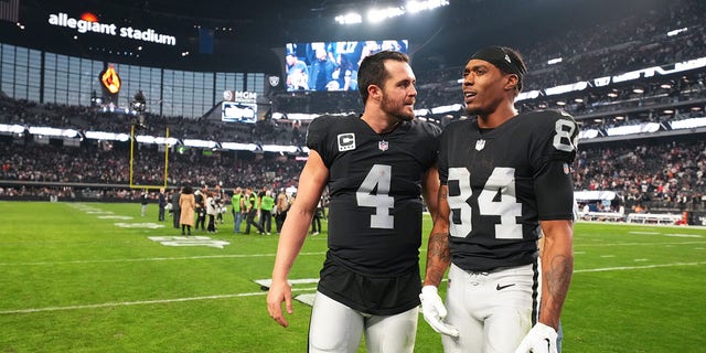 Las Vegas Raiders quarterback Derek Carr, #4, speaks with wide receiver Keelan Cole, #84, after their win against the New England Patriots at Allegiant Stadium on December 18, 2022 in Las Vegas .  The Raiders defeated the Patriots 30-24. 