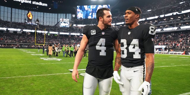 Las Vegas Raiders quarterback Derek Carr, #4, speaks to wide receiver Keelan Cole, #84, after their victory against the New England Patriots at Allegiant Stadium on Dec. 18, 2022 in Las Vegas. The Raiders defeated the Patriots 30-24. 