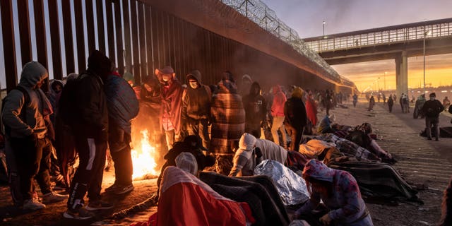 Illegal immigrants gather next to the U.S.-Mexico border fence in El Paso, Texas, on Dec. 22, 2022. 