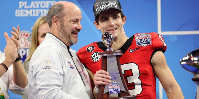 Stetson Bennett of the Georgia Bulldogs receives the Most Outstanding Player award after defeating the Ohio State Buckeyes in the Chick-fil-A Peach Bowl at Mercedes-Benz Stadium on December 31, 2022 in Atlanta.