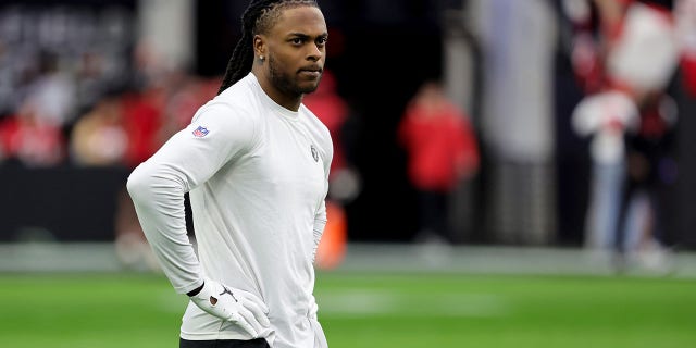 Las Vegas Raiders wide receiver Davante Adams, number 17, stands on the field while warming up before a game against the San Francisco 49ers at Allegiant Stadium on January 1, 2023 in Las Vegas, Nevada.  The 49ers defeated the Raiders 37-34 in overtime. 