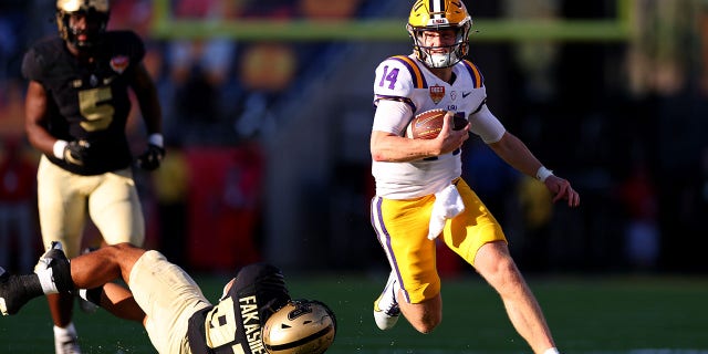 Walker Howard #14 of the LSU Tigers scrambles during the Cheez-It Citrus Bowl against the Purdue Boilermakers at Camping World Stadium on January 02, 2023 in Orlando, Florida.