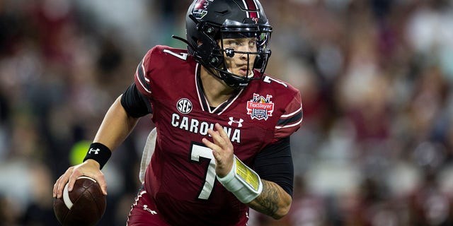 Spencer Rattler of the South Carolina Gamecocks looks to pass against the Notre Dame Fighting Irish during the TaxSlayer Gator Bowl at TIAA Bank Field on Dec. 30, 2022, in Jacksonville, Florida.