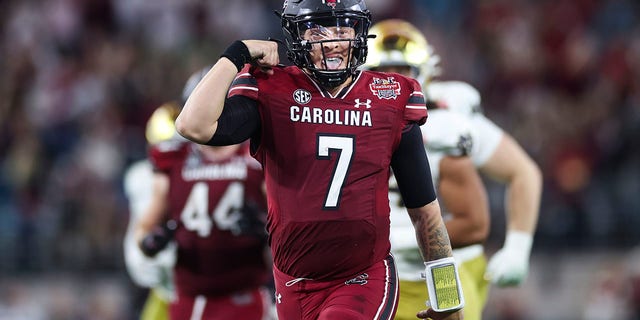 Spencer Rattler of South Carolina celebrates after scoring a touchdown against Notre Dame during the TaxSlayer Gator Bowl on Dec. 30, 2022, in Jacksonville, Florida.