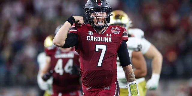 South Carolina's Spencer Rattler celebrates after scoring a touchdown against Notre Dame during the TaxSlayer Gator Bowl on December 30, 2022 in Jacksonville, Florida.