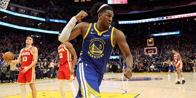 The Warriors' Kevon Looney reacts after he made the game-winning shot at double overtime to beat the Hawks on January 2, 2023.