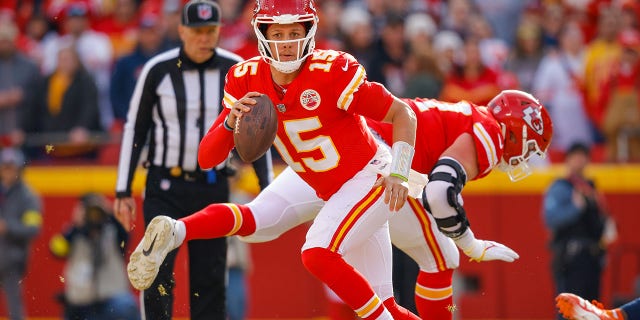 Patrick Mahomes #15 of the Kansas City Chiefs escapes defensive pressure by the Denver Broncos during the second quarter at Arrowhead Stadium on January 1, 2023 in Kansas City, Missouri. 