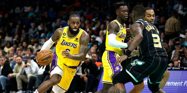 LeBron James, #6 of the Los Angeles Lakers, drives to the basket during the second half of the game against the Charlotte Hornets at Spectrum Center on January 2, 2023, in Charlotte, North Carolina. 