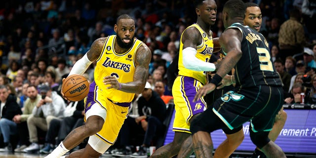 LeBron James, #6 of the Los Angeles Lakers, drives to the basket during the second half of the game against the Charlotte Hornets at Spectrum Center on January 2, 2023, in Charlotte, North Carolina.