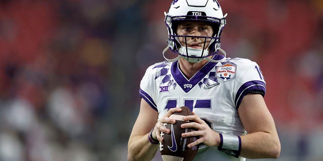 TCU Horned Frogs quarterback Max Duggan, #15, warms up before the Vrbo Fiesta Bowl against the Michigan Wolverines at State Farm Stadium on December 31, 2022, in Glendale, Arizona. 