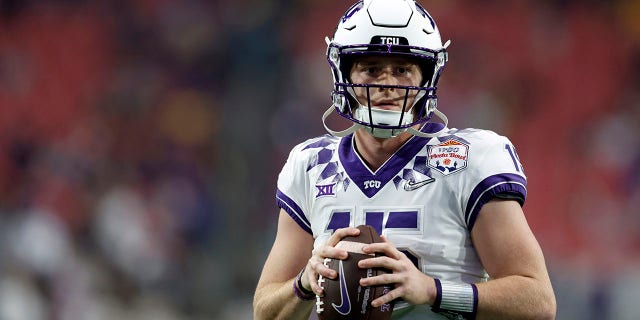 TCU Horned Frogs quarterback Max Duggan, #15, warms up before the Vrbo Fiesta Bowl against the Michigan Wolverines at State Farm Stadium on December 31, 2022, in Glendale, Arizona. 