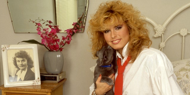 Tracey Bregman poses for a portrait with her dog in Los Angeles circa 1985.