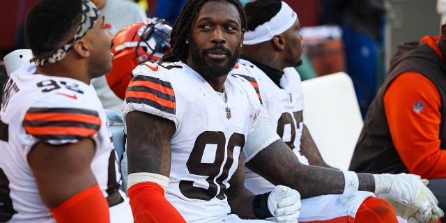 Jadeveon Clowney, #90 of the Cleveland Browns, interacts with Myles Garrett, #95, on the sideline during the second half of the game against the Washington Commanders at FedExField on January 1, 2023, in Landover, Maryland. 