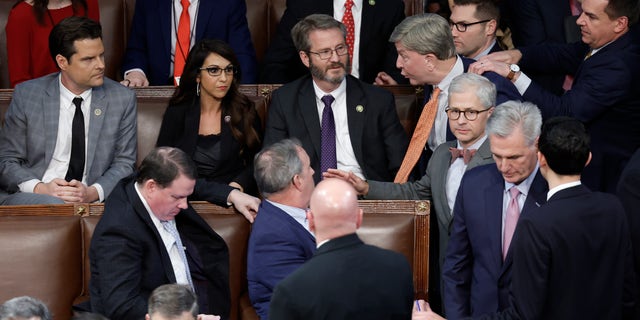 U.S. Rep.-elect Mike Rogers (R-AL) is restrained by Rep.-elect Richard Hudson (R-NC) after getting into an argument with Rep.-elect Matt Gaetz (R-FL) as House Republican Leader Kevin McCarthy (R-CA) walks away, in the House Chamber during the fourth day of elections for Speaker of the House.